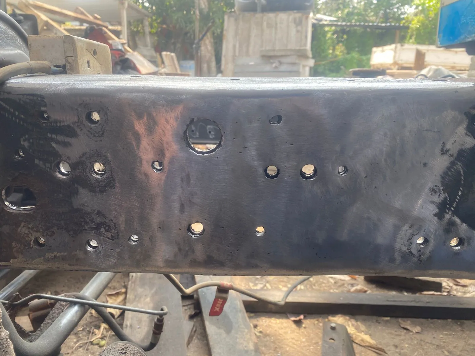 Chassis rail cleaned and prepped with drilled holes