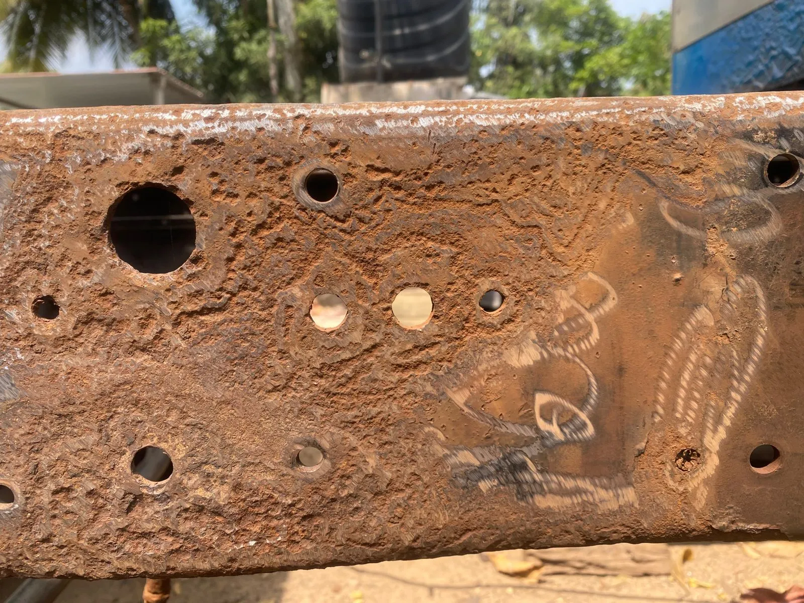 Heavily rusted chassis beam — severe corrosion
